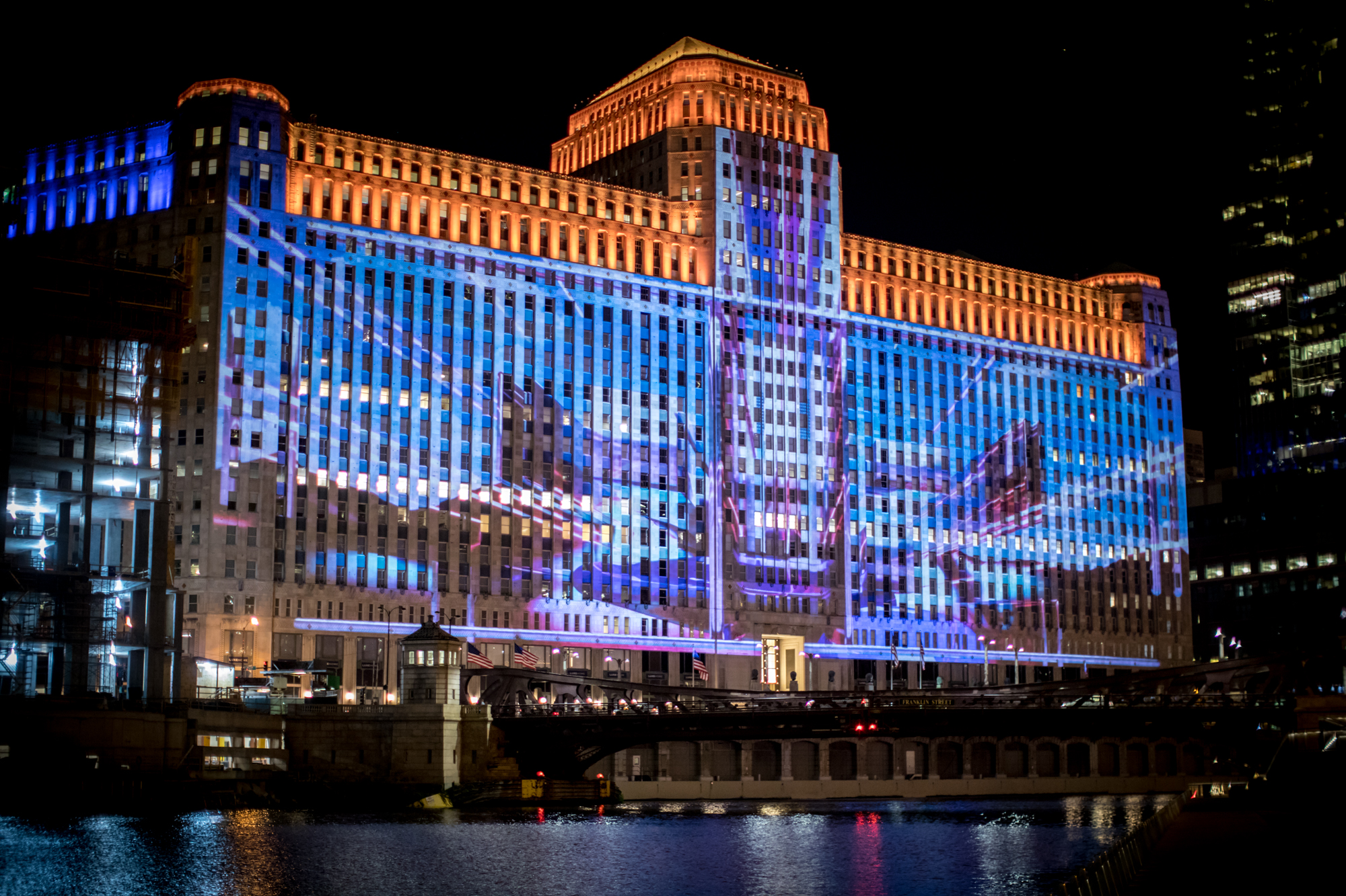 art projected on building facade by lighting design company