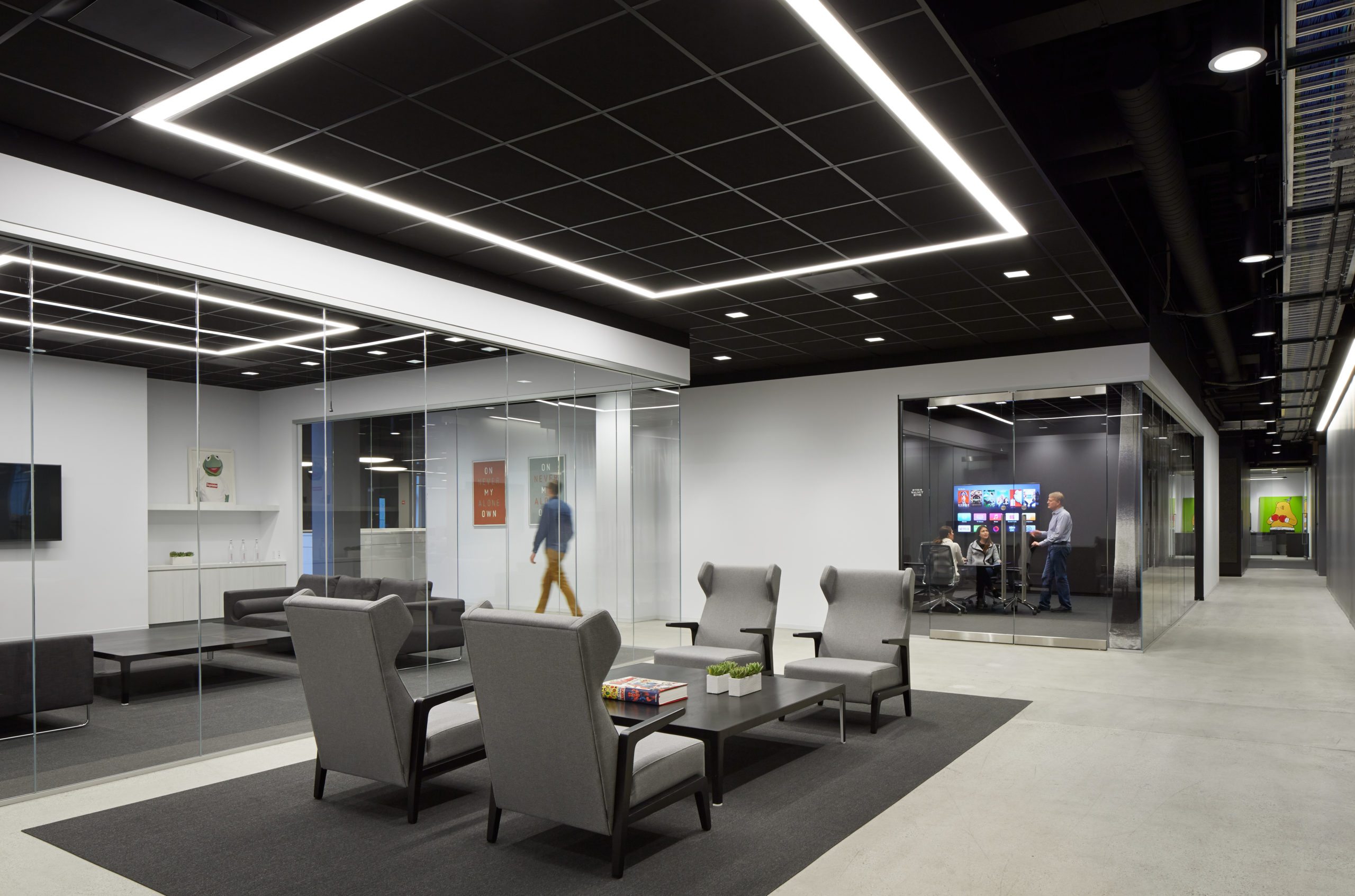 office common area with chairs and architectural lighting design
