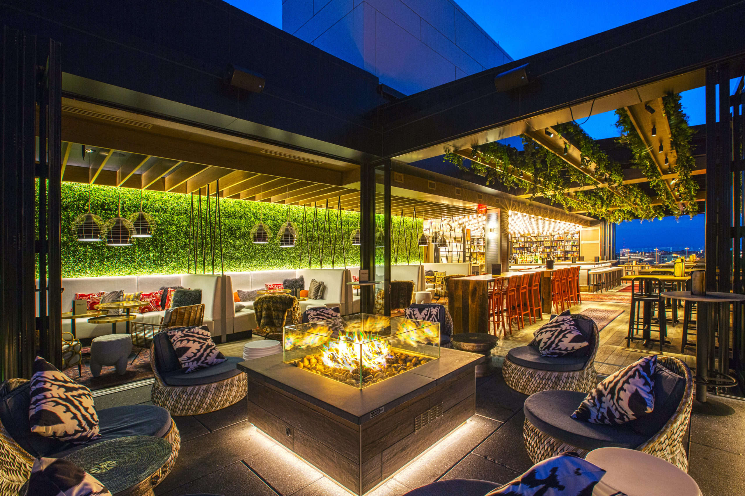 illuminated rooftop bar at night with architectural lighting